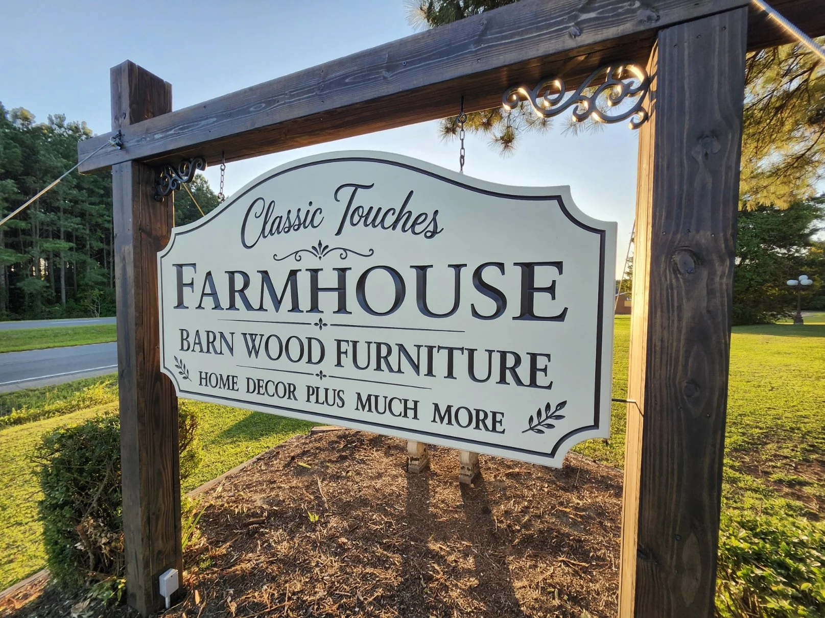 Custom hanging business sign for Classic Touches Farmhouse, featuring dimensional lettering and a decorative cream panel suspended from wooden posts.