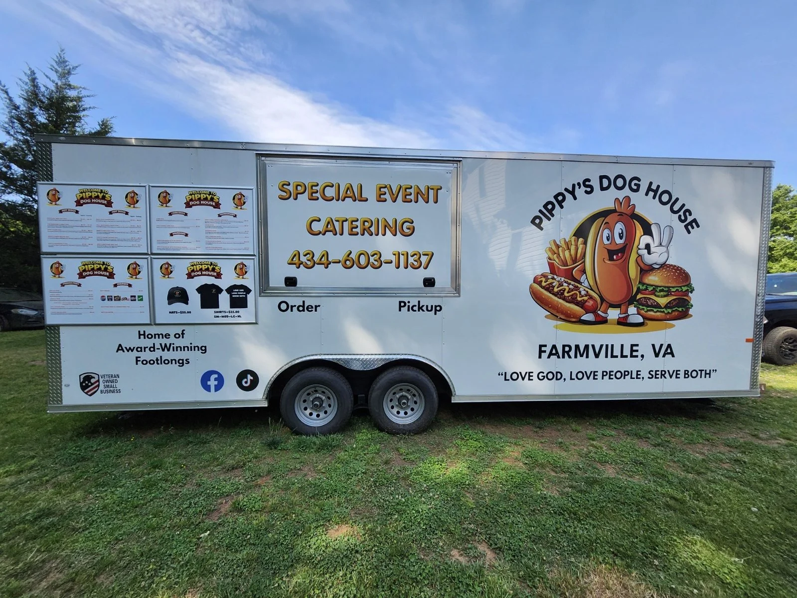 Custom food trailer graphics and menu boards by Outpost Signs for Pippy’s Dog House in Farmville, Virginia—bringing their brand and menu to customers wherever they go. Pippy’s Dog House food trailer with custom graphics, hot dog mascot, menu boards, 