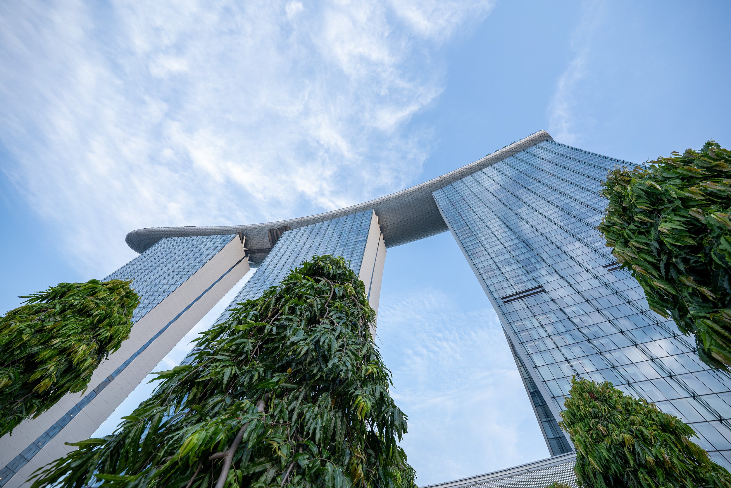 marina bay hotel in singapore - view of the pool and towers from below with blu sky
