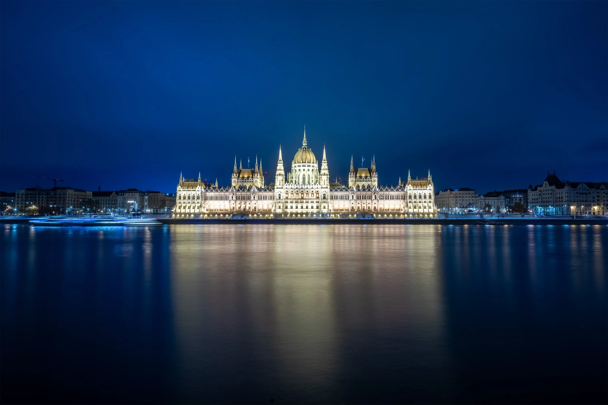 long exposure with dramatic blue sky of hungarian parliament in budapest at winter