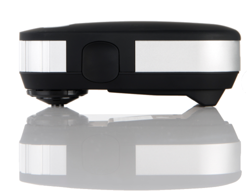 Close-up of a black and white robotic vacuum cleaner on a reflective surface.