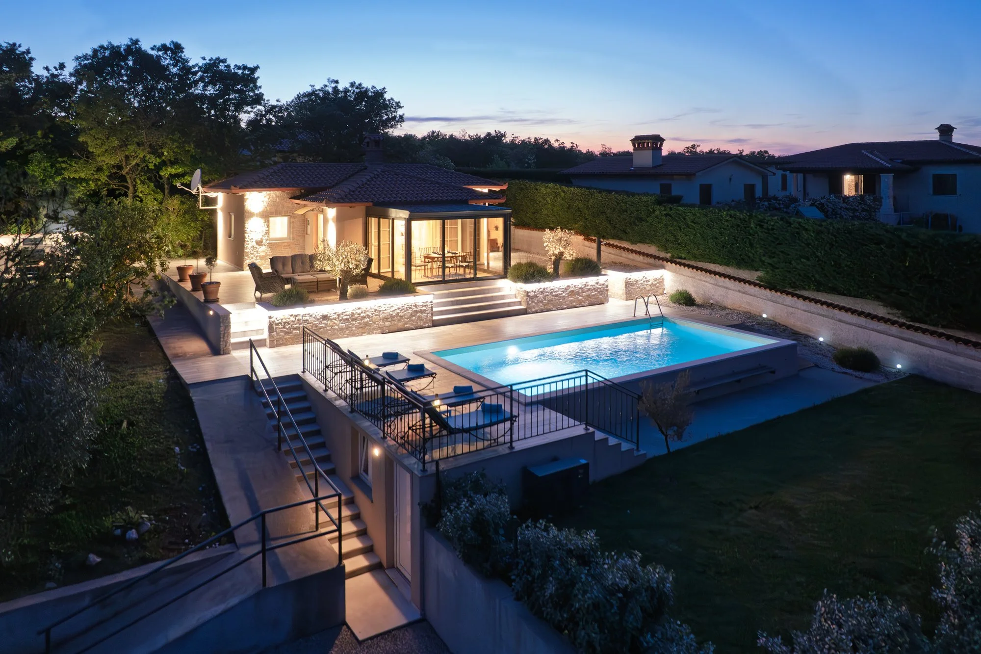 Evening view of a holiday villa with outdoor lighting