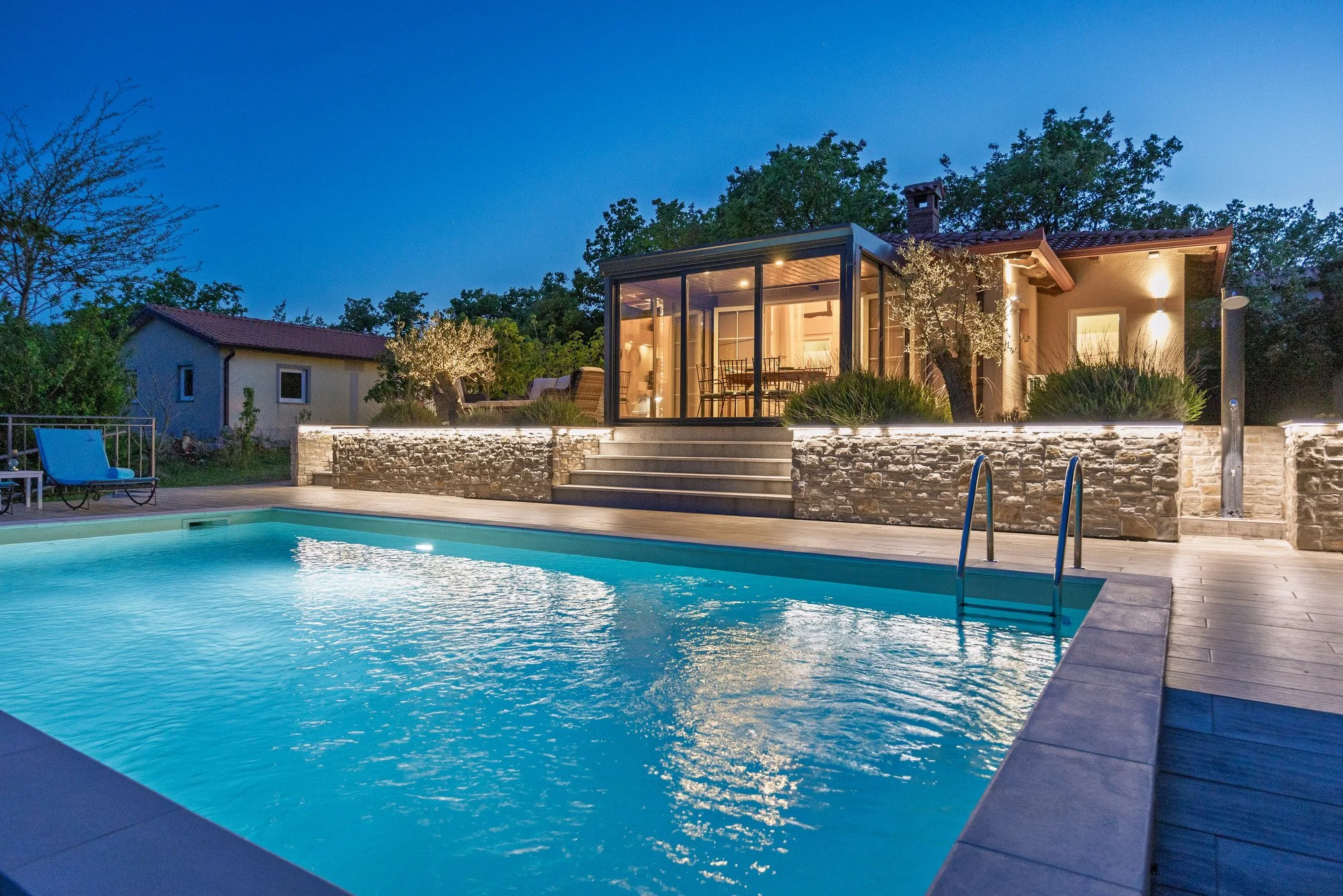 Outdoor pool at night in a luxury holiday home in Istria