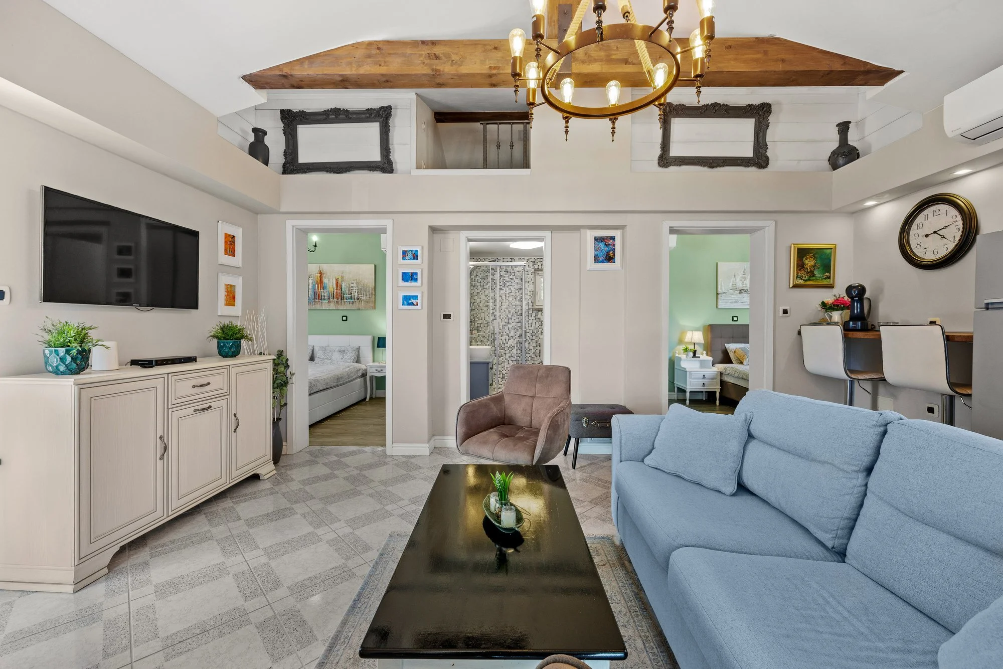 Living room with a statement chandelier and wooden ceiling beam in a luxury villa in Istria