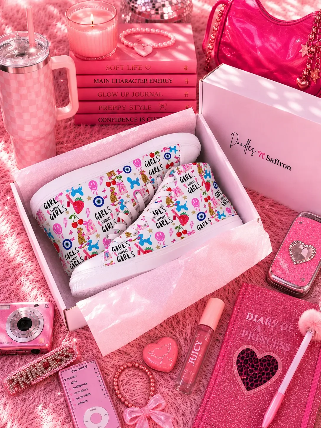 White graphic high-top canvas sneakers inside a retail shipping box surrounded by pink preppy aesthetic stationery accessories.