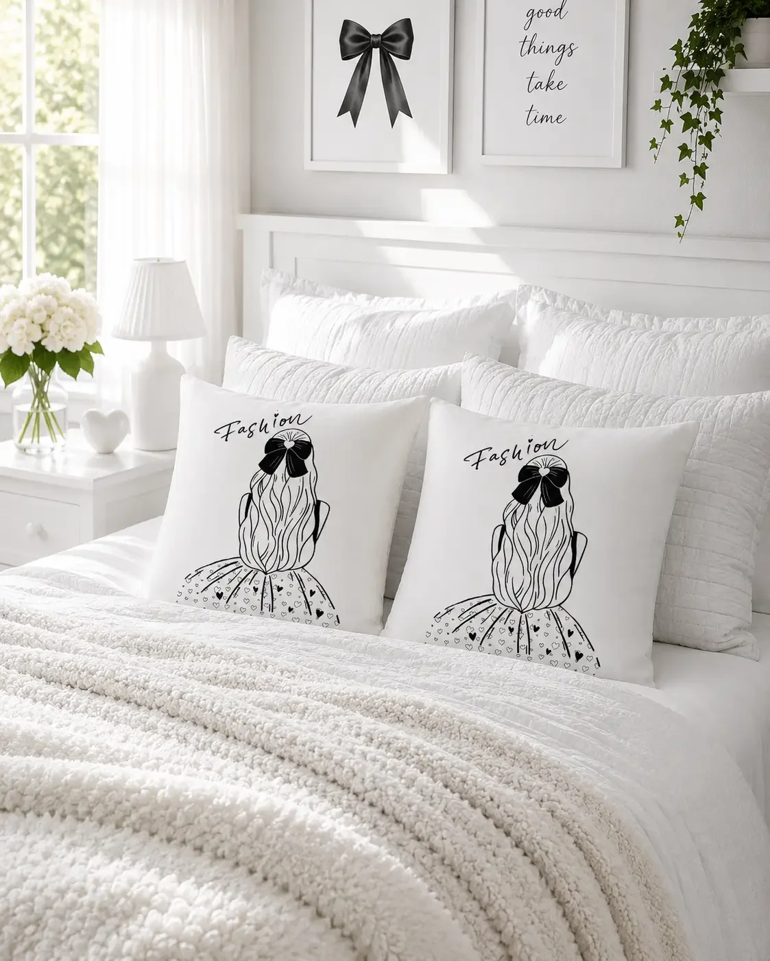 Two square white accent pillows featuring a black line art graphic of a girl wearing a bow and dress on a made bed.