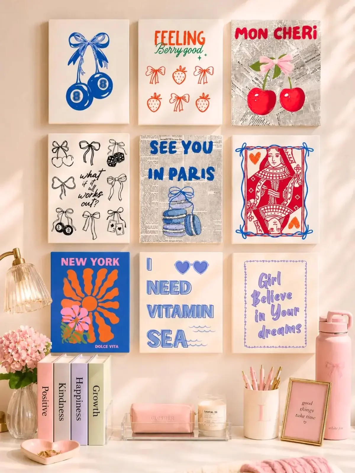 Doodles and Saffron preppy coastal wall art gallery bundle with cherry, bow, and travel posters over a white desk.