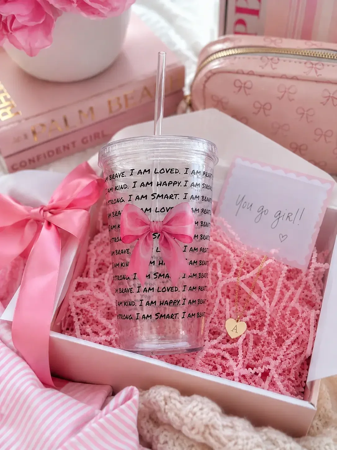 Preppy daily affirmation tumbler cup with a pink bow in a gift box with a "you go girl!" card and heart necklace.
