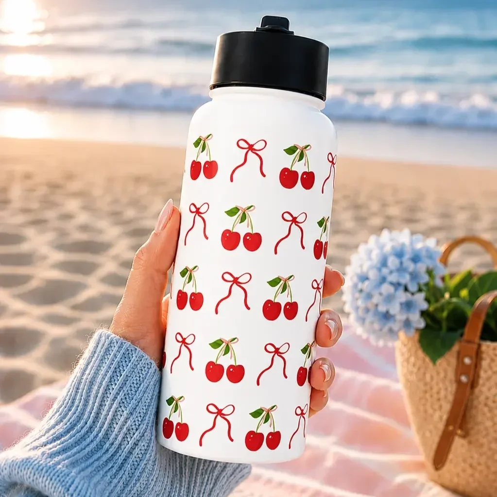 cherry-bow-insulated-water-bottle-beachfront-lifestyle.webp