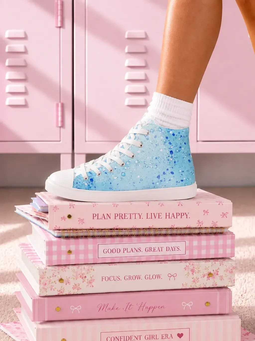 blue-paint-splatter-canvas-sneakers-stacked-notebooks-view.webp
