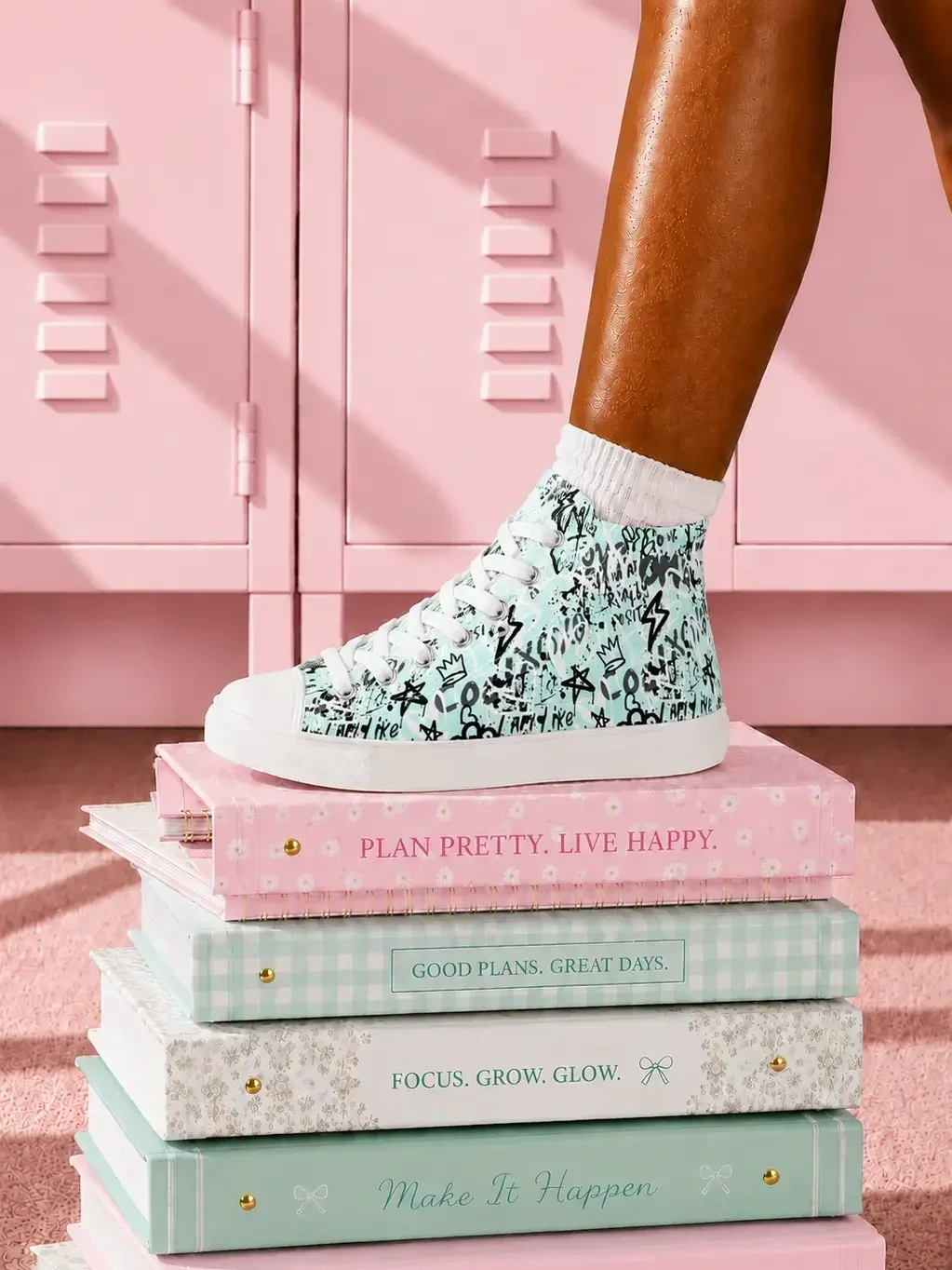mint-green-graffiti-canvas-sneakers-stacked-notebooks-view.webp