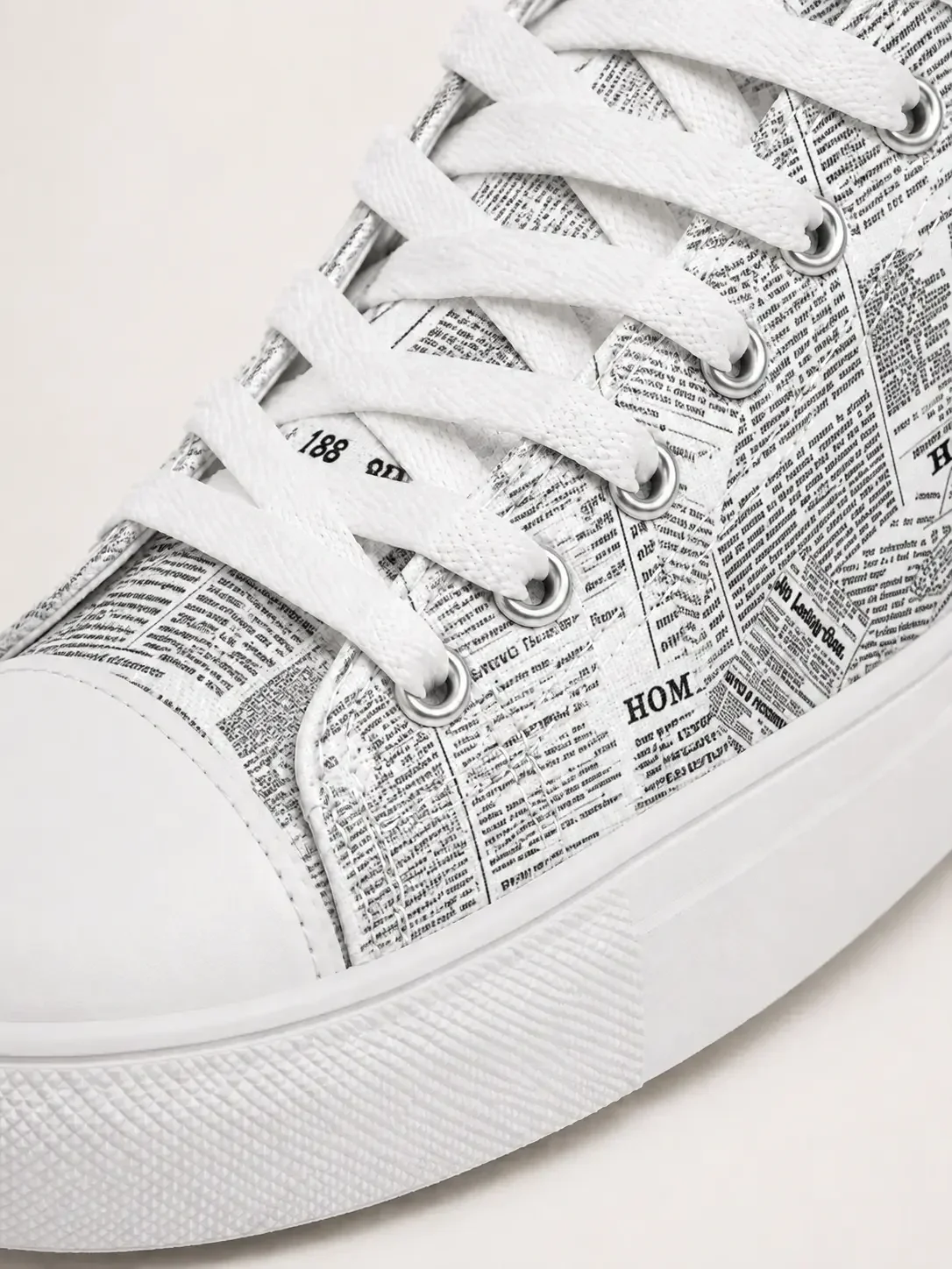 newspaper-print-canvas-sneaker-close-up-view.webp