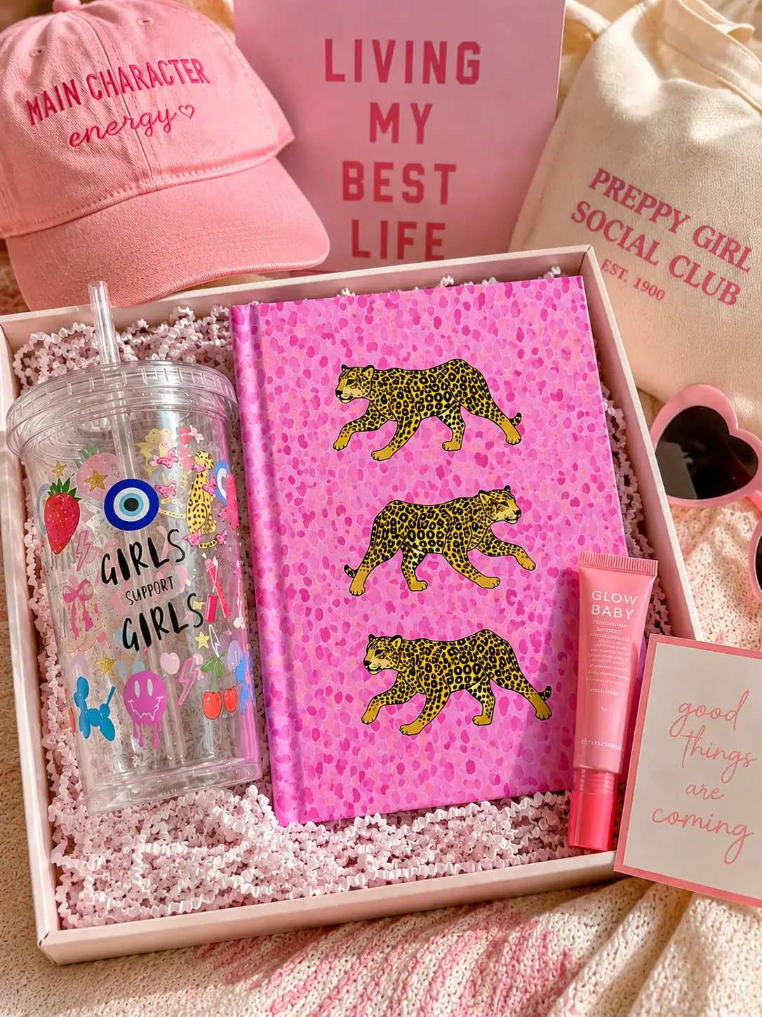 Preppy pink gift box filled with a matching leopard print journal, girls support girls tumbler, baseball cap, and lip gloss.