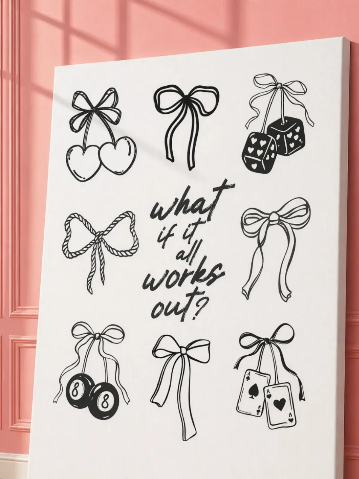 An angled close-up view of a vertical white canvas displaying black ribbon bow doodles surrounding an inspirational handwritten quote.