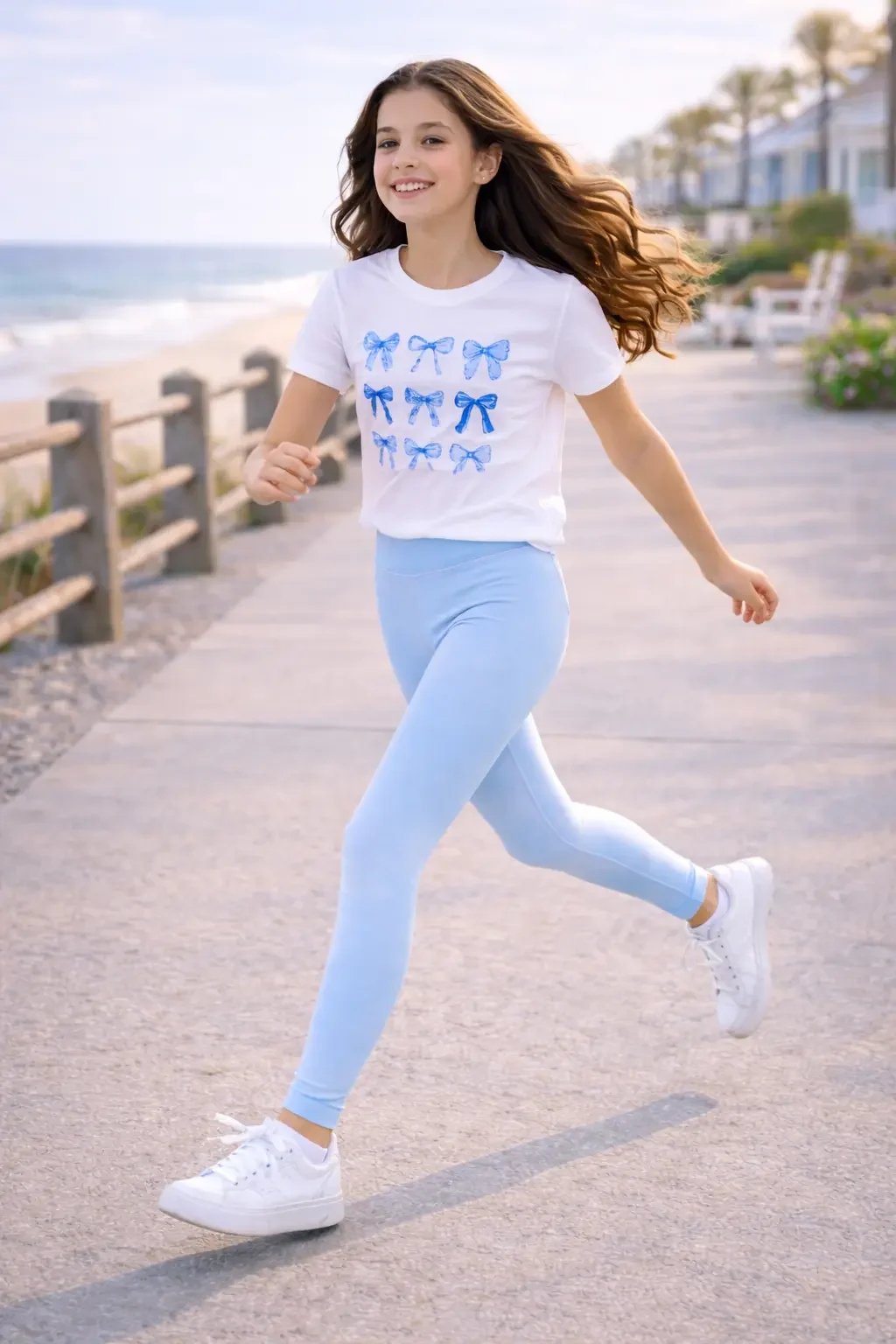 Action shot of girls light blue high-waisted athletic leggings, showing a flexible full-length fit on an outdoor running path.