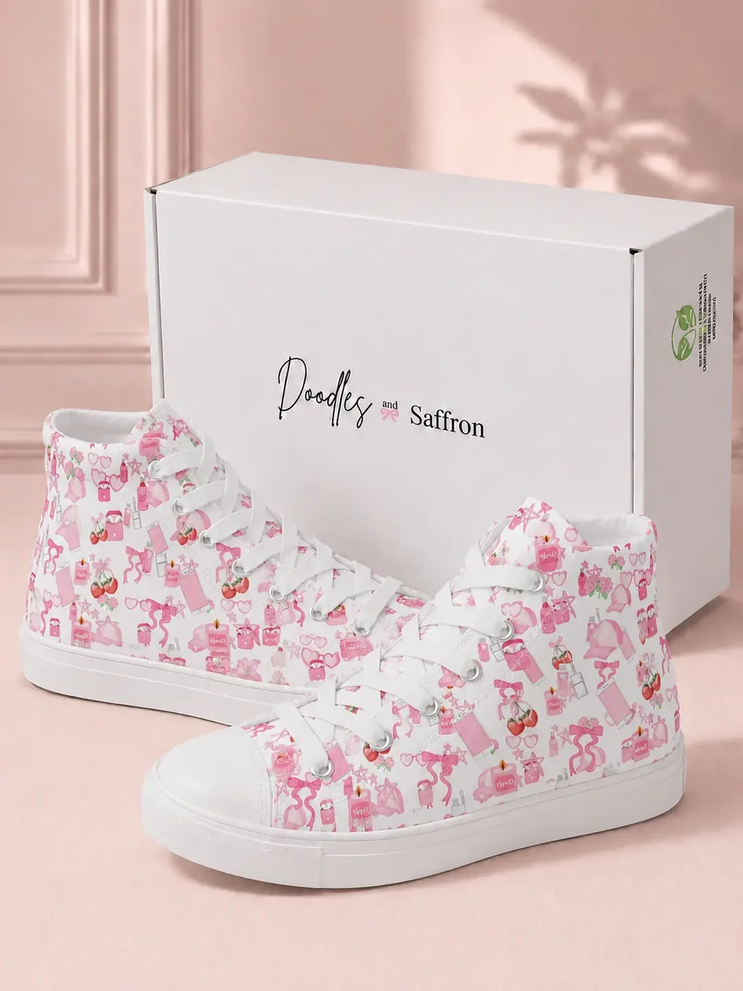Pair of white high-top canvas sneakers with a pink doodle print standing in front of a white retail shipping box.