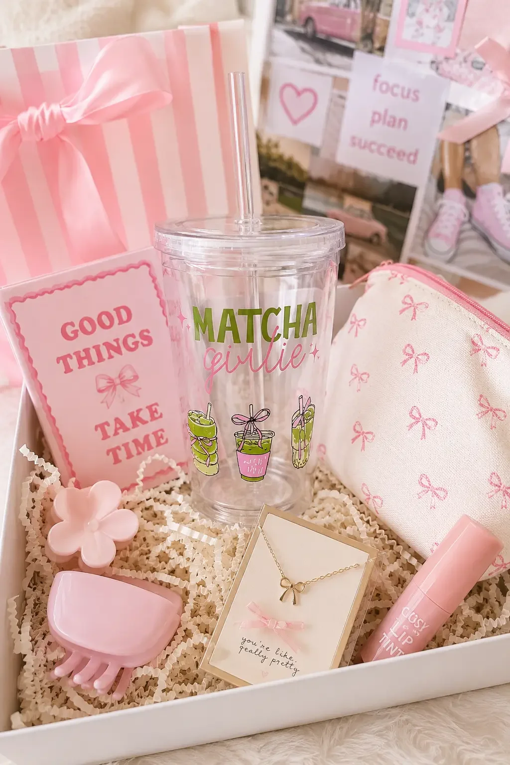 A preppy gift box containing a "Matcha Girlie" tumbler cup, bow makeup bag, lip tint, hair claw clips, and a bow necklace.
