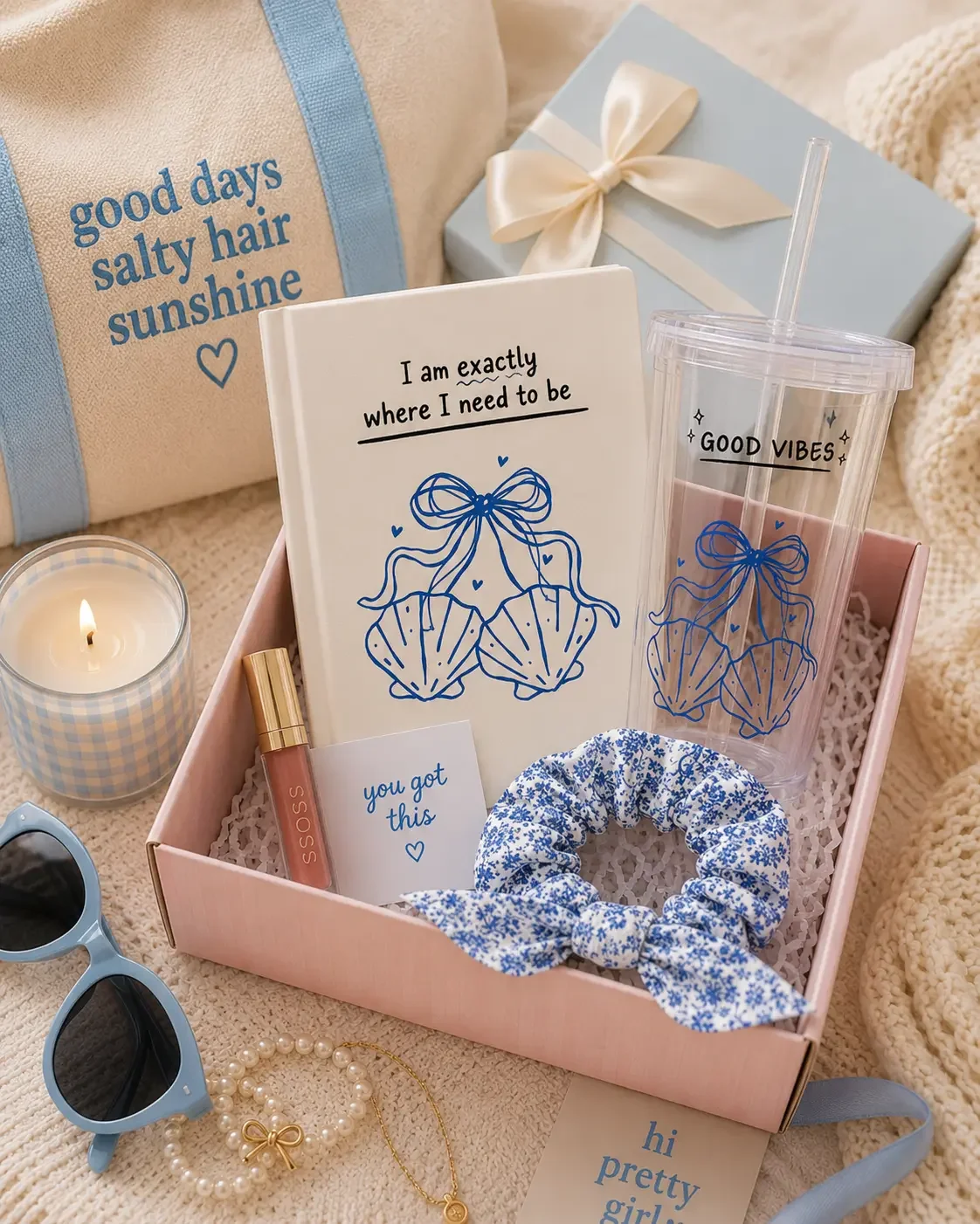 Coastal themed gift box filled with a matching blue seashell journal, good vibes tumbler, floral scrunchie, and canvas tote bag.