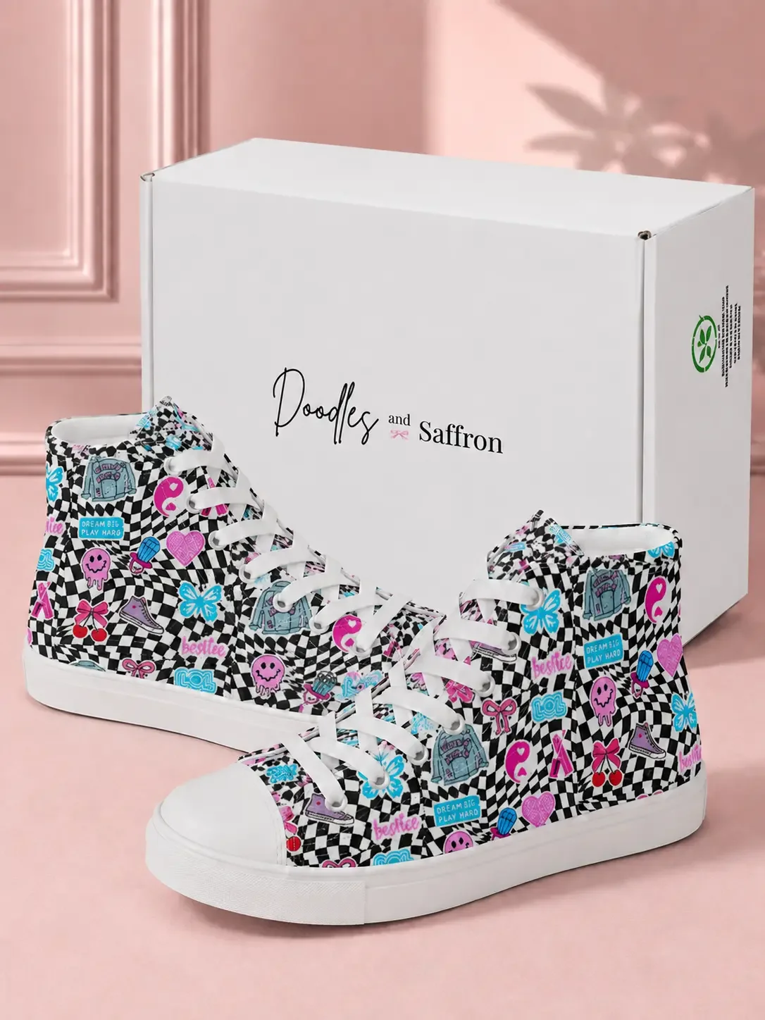 Pair of black and white checkered high-top canvas sneakers with colorful sticker doodles by a branded shipping box.