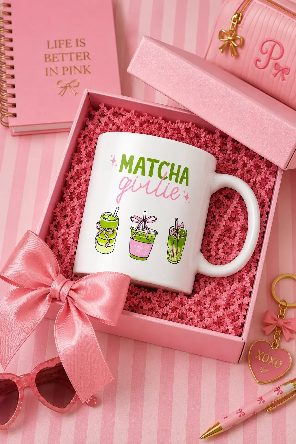 White Matcha Girlie ceramic mug nestled in an opened pink gift box with a satin bow, surrounded by matching stationery.
