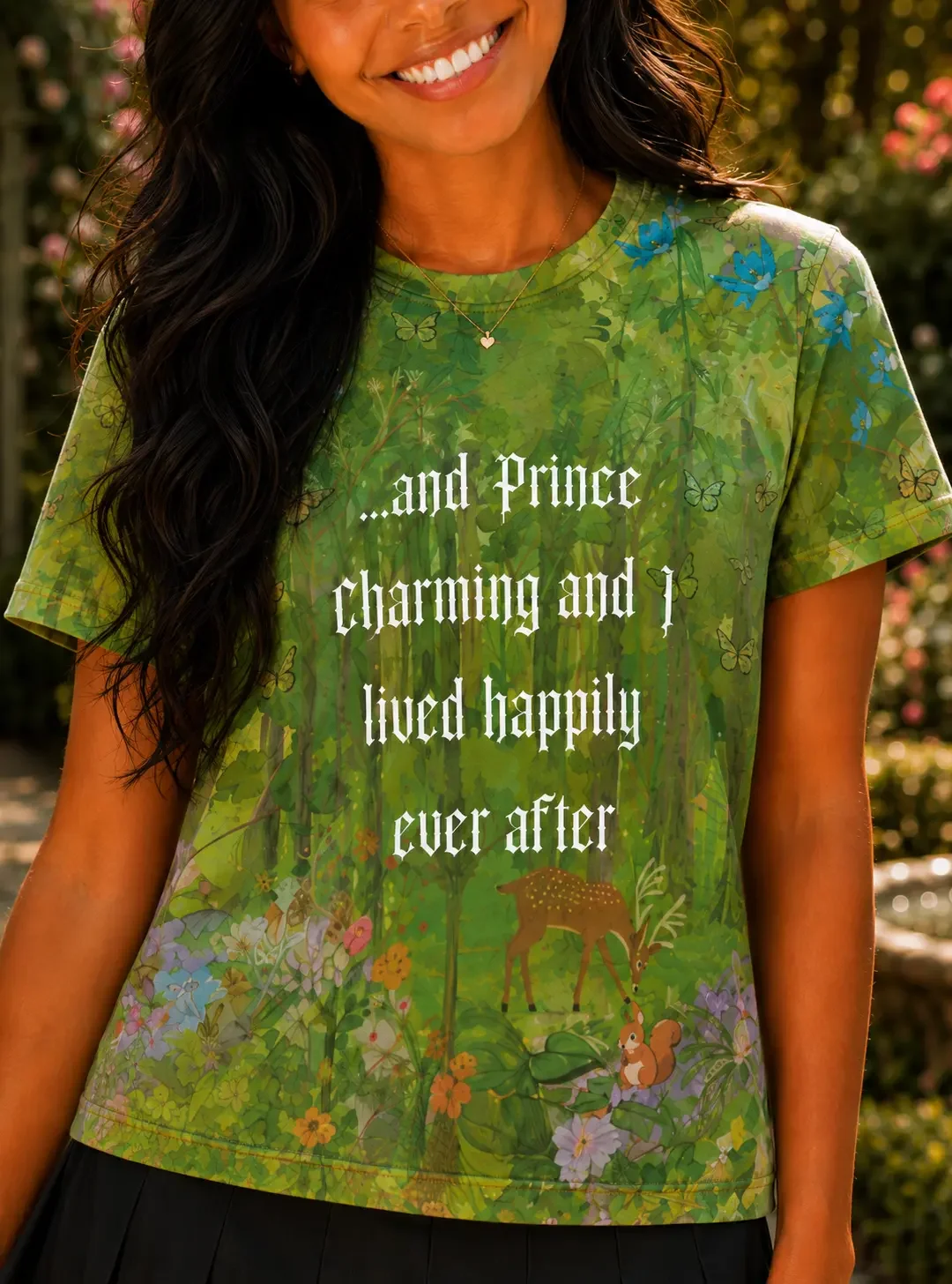 Close-up of a green enchanted forest t-shirt with Prince Charming graphic text paired with a black skirt.