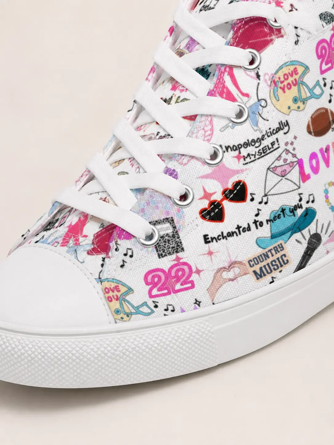 Close-up detail of white laces, eyelets, and a canvas material featuring a colorful music doodle pattern with lyrics.