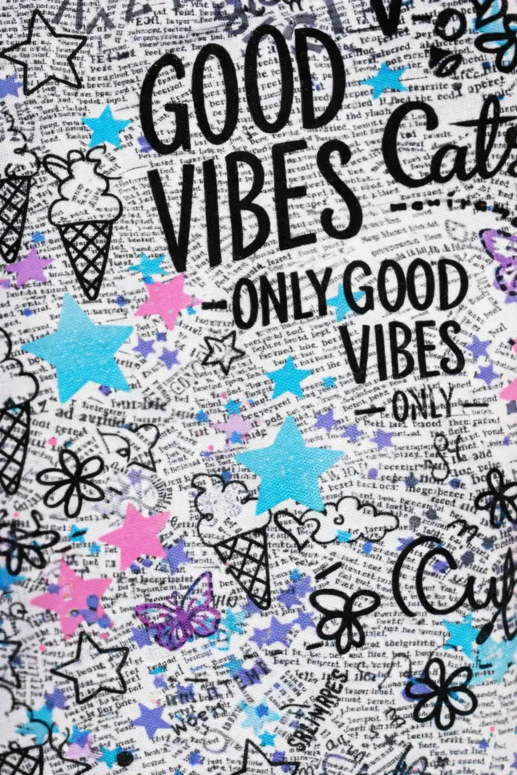 Macro texture view of a vibrant preppy Y2K doodle pattern backdrop showing black street art style graphics overlaying a colorful watercolor and starry sky print background.
