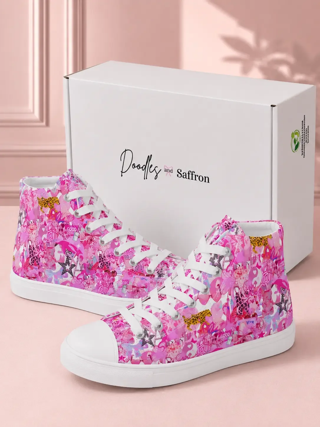 Pair of bright pink graffiti print canvas high-top sneakers standing in front of a white retail shipping box by a pool.