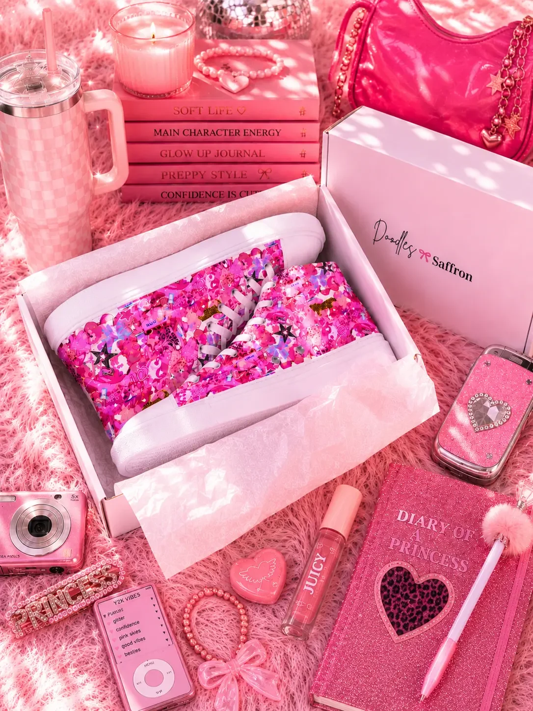 Vibrant pink graffiti high-top sneakers inside a shipping box surrounded by pink preppy aesthetic accessories.