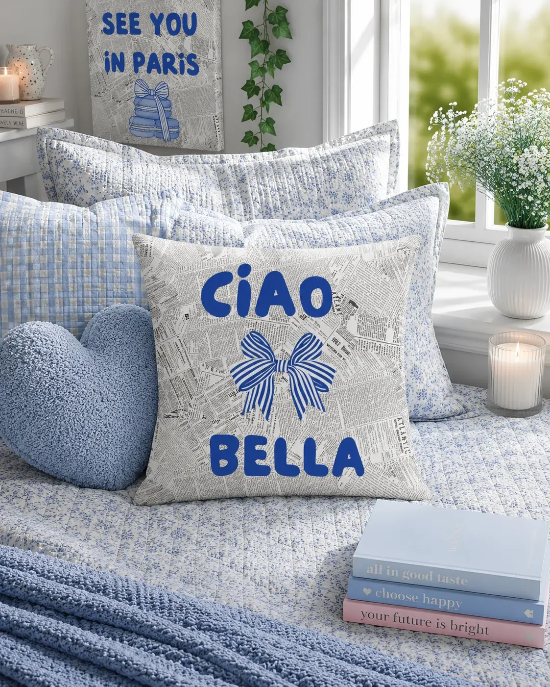 A square throw pillow with a vintage newspaper print background, a blue striped bow, and bold blue text reading Ciao Bella.