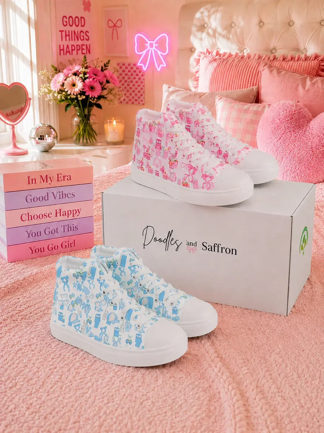 Pink and blue coquette pattern high-top sneakers displayed on a bed with a Doodles and Saffron retail shipping box.