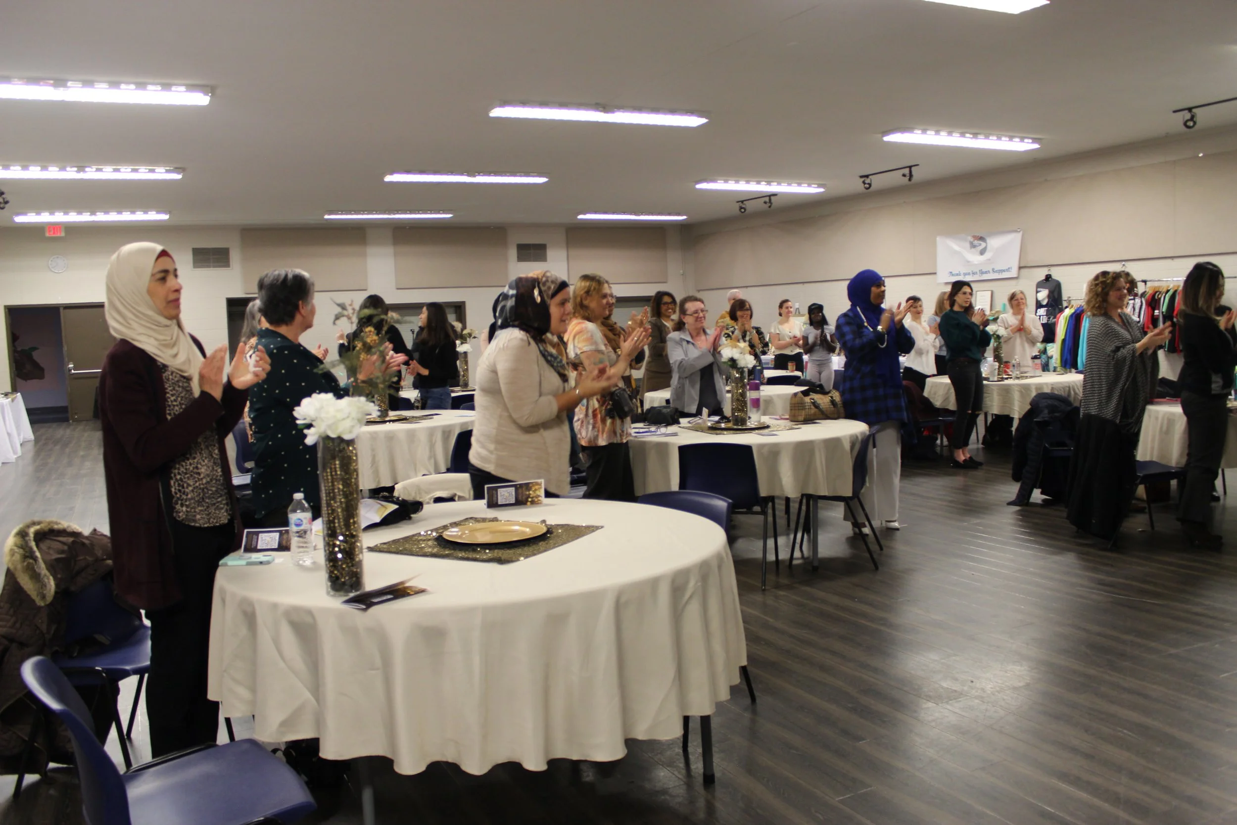 Women of faith gathering and drumming with indigenous speaker at conference in Calgary