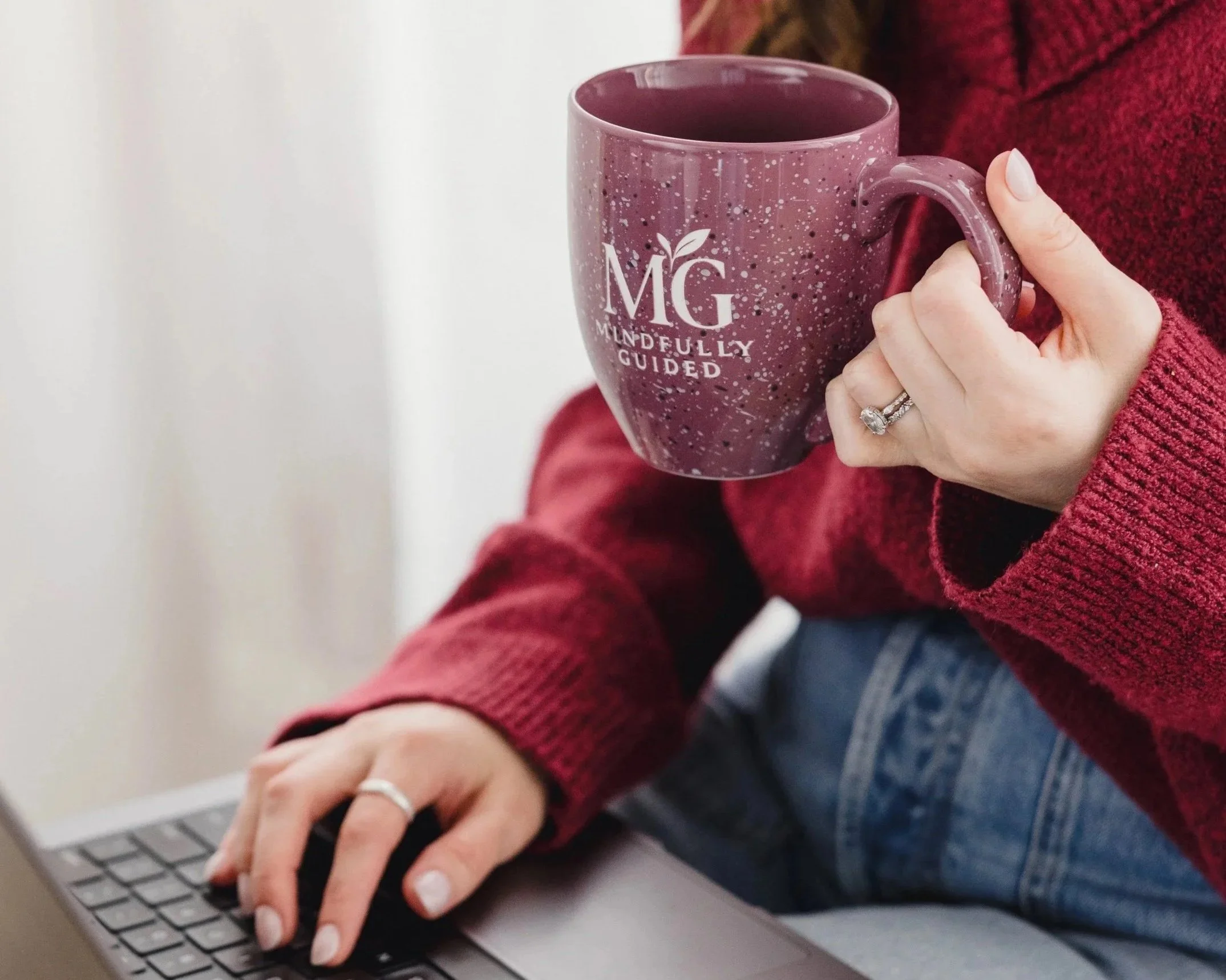 Alexis Culhane, ADHD and neurodivergent-affirming dietitian, sipping from a Mindfully Guided mug at her laptop