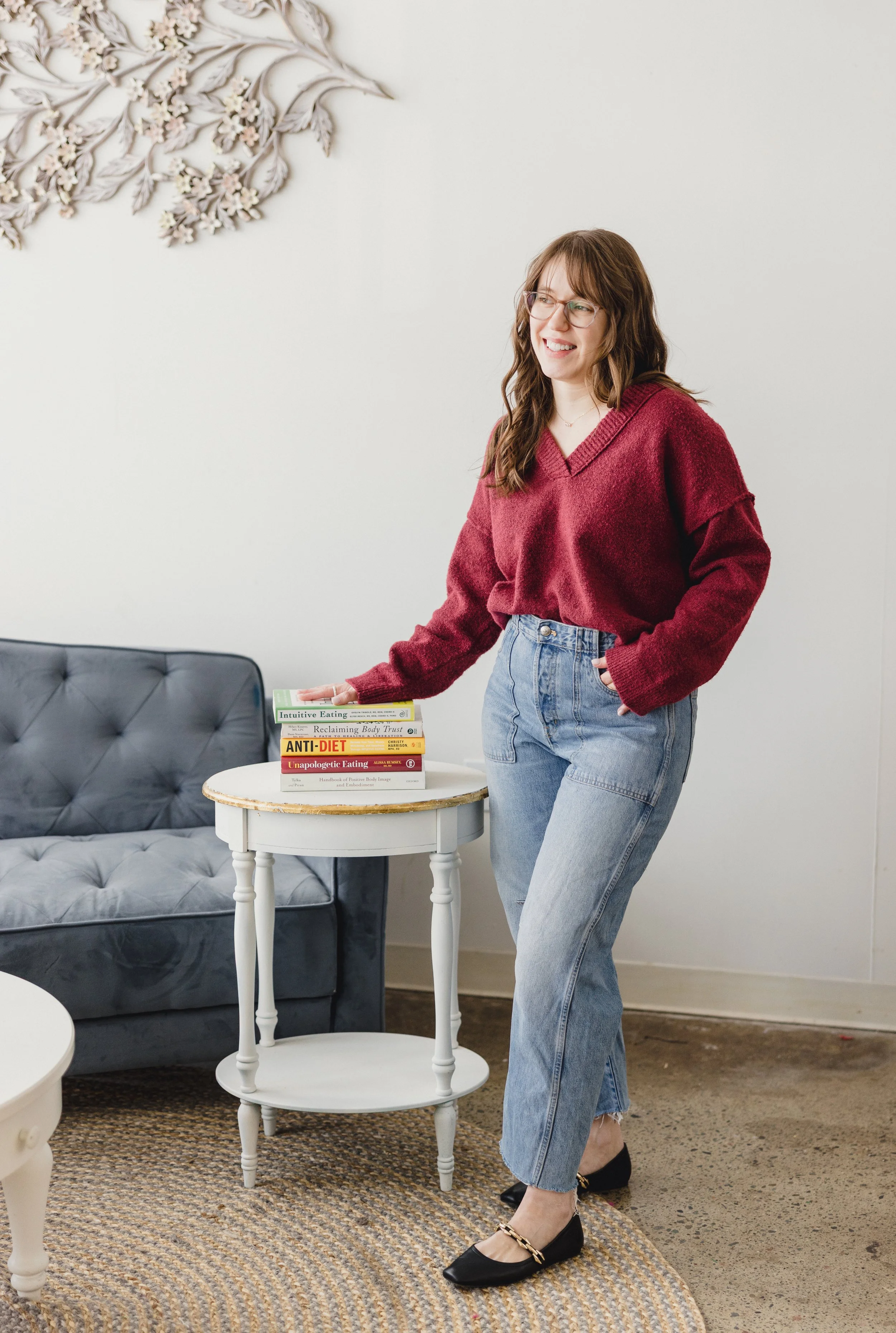 Alexis, weight-neutral Registered Dietitian and Body Trust® Provider, standing in her home office space