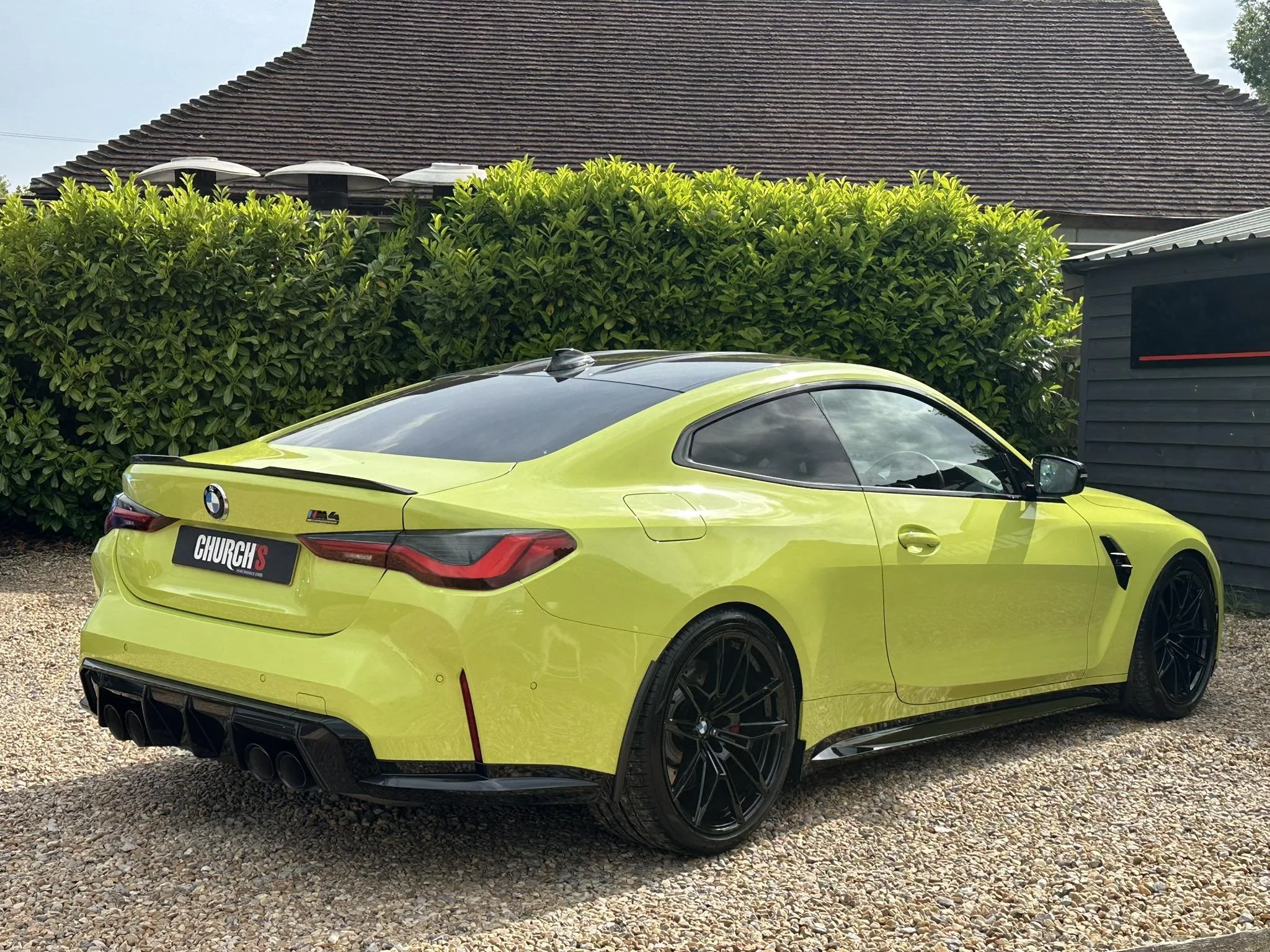 A BMW M4 Competition in lime green bought by Church's.