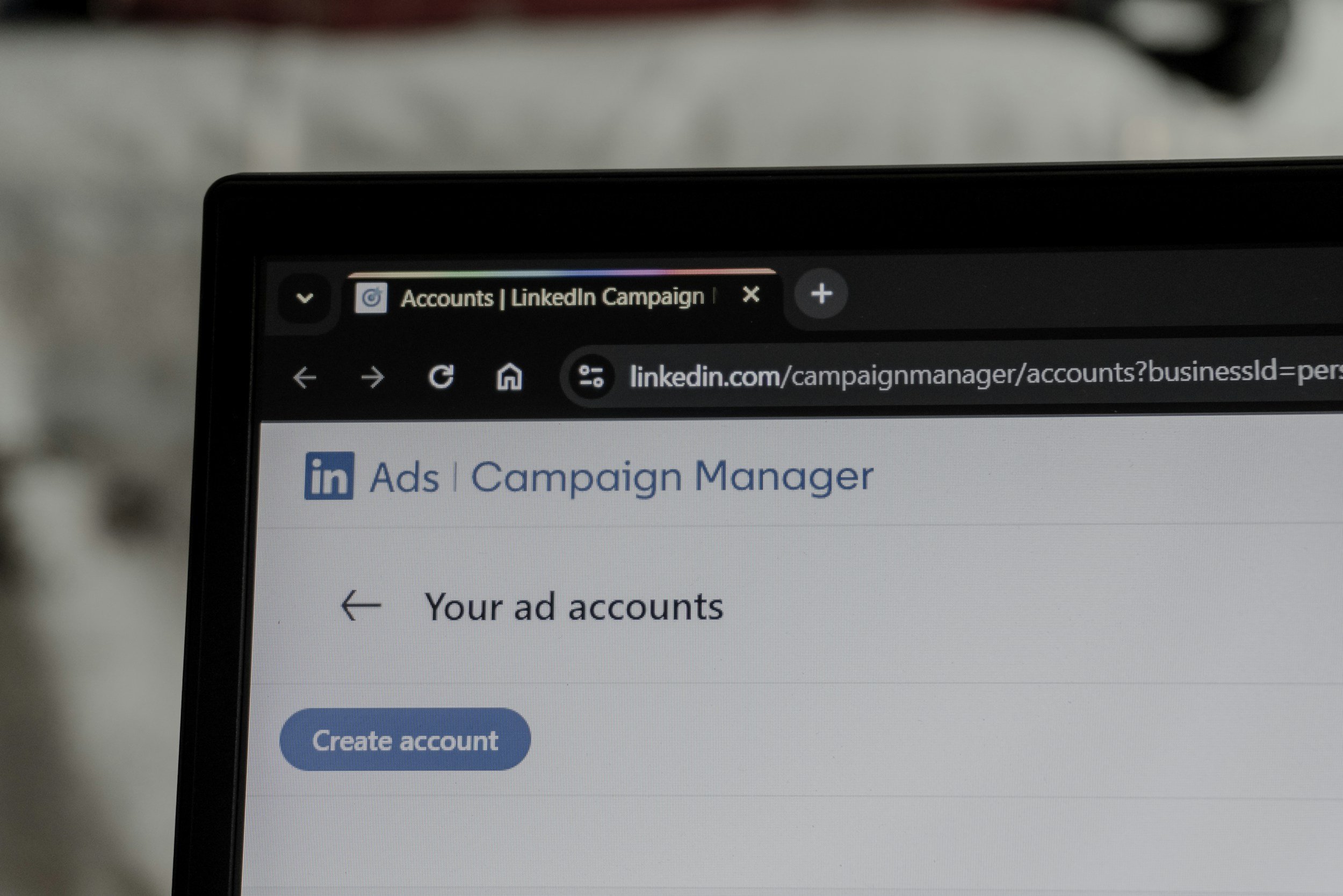 Computer screen displaying LinkedIn Ads Campaign Manager page with options to view ad accounts and create a new account.