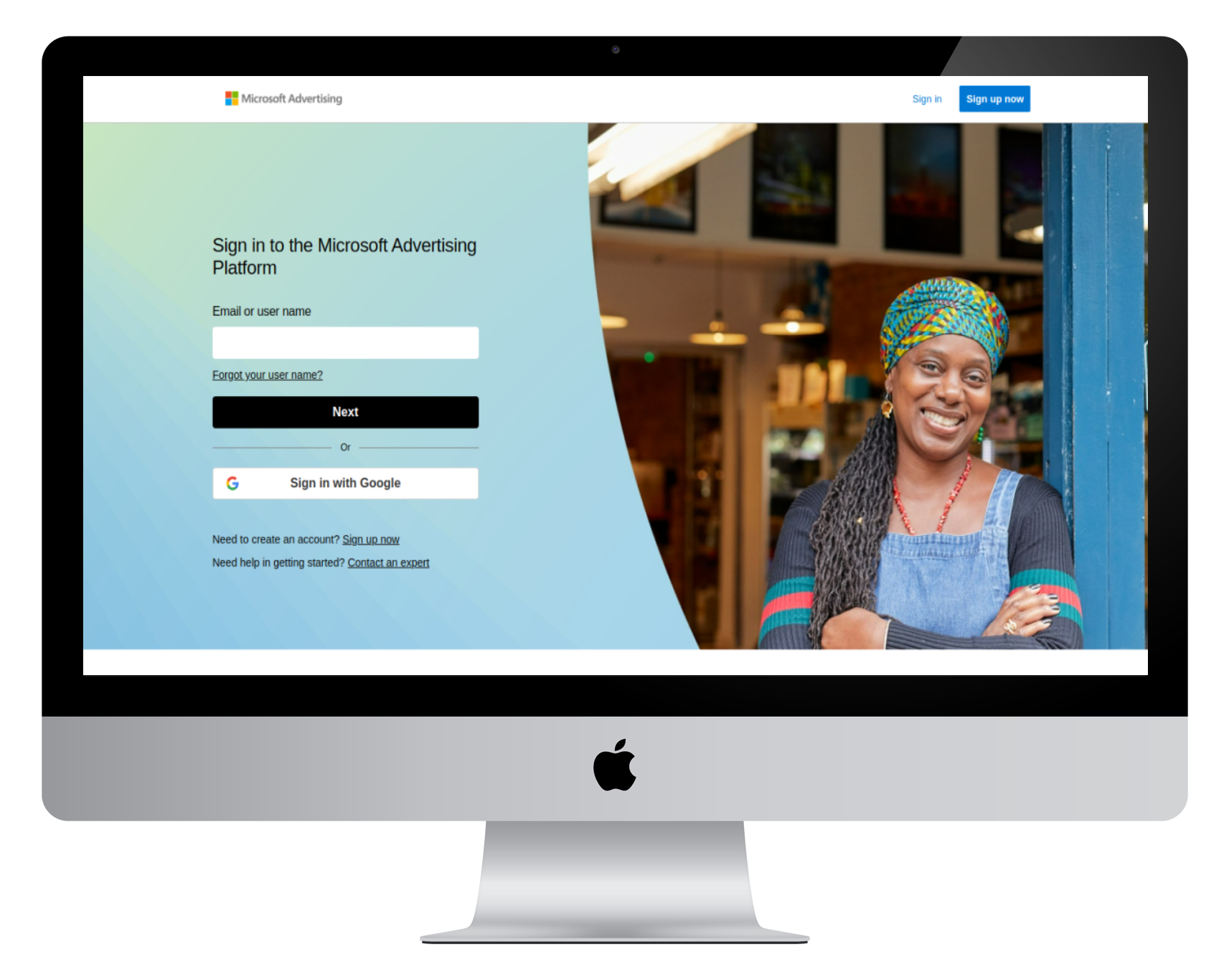 Computer screen displaying the Microsoft Advertising sign-in page, with a smiling woman wearing a colorful headwrap and denim shirt on the right side.