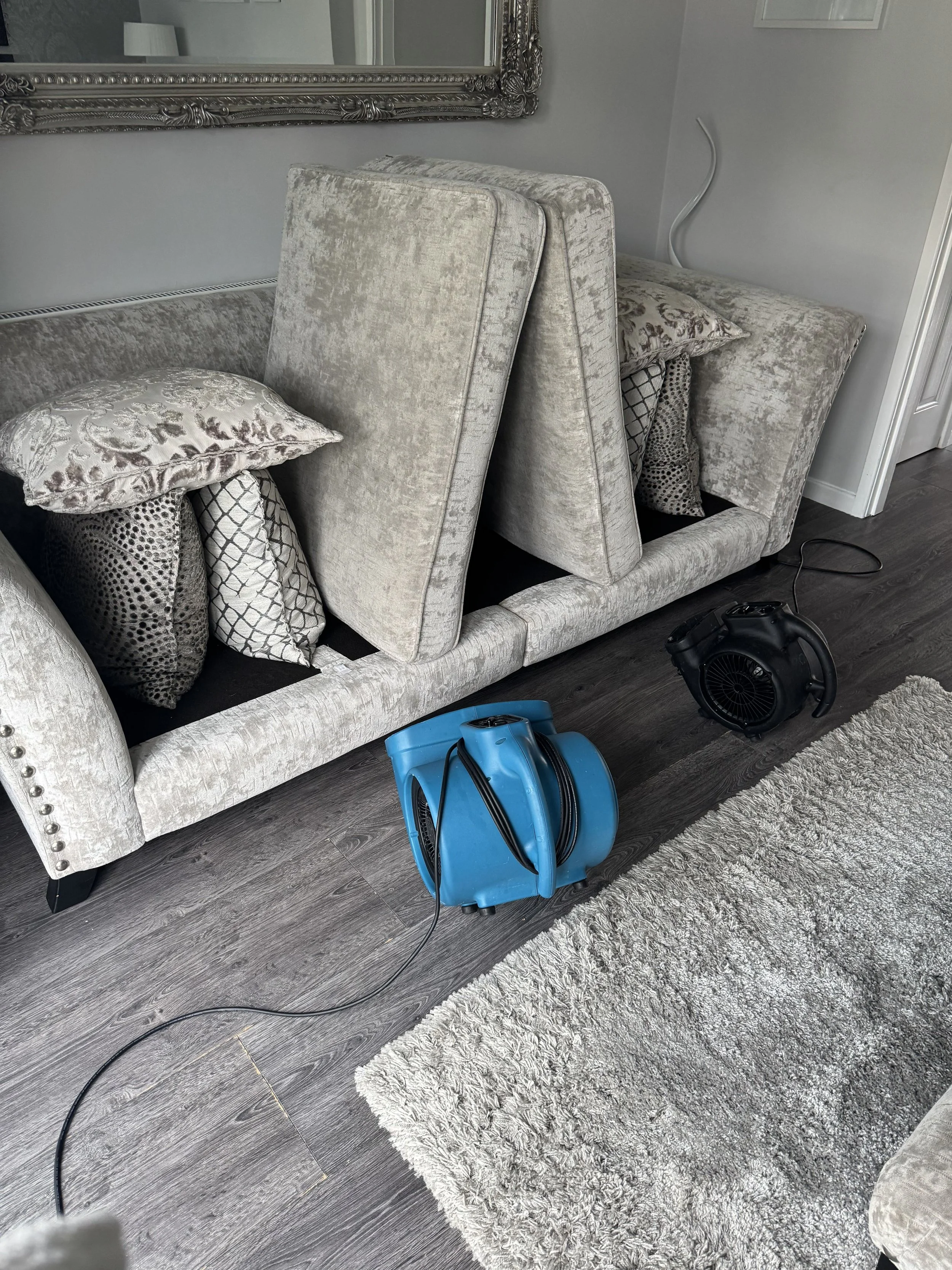 Clean sofa being dried quickly with air blowers after professional upholstery cleaning service