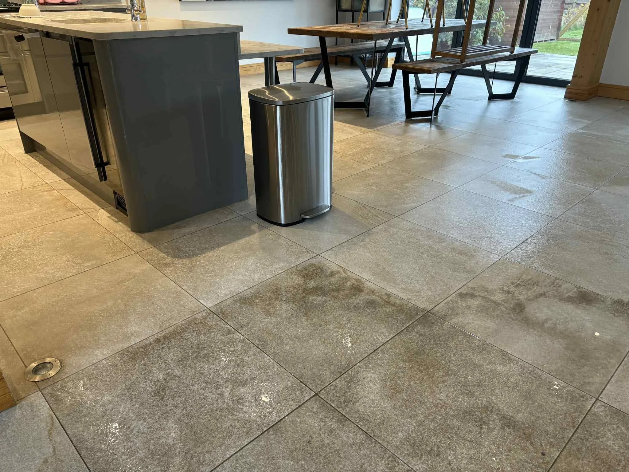 Before and after polished travertine floor restoration in Clitheroe showing cleaned and uncleaned sections