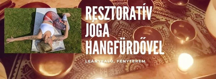 A woman practicing yoga outdoors on a mat beside grass, with candles and decorative objects on a table, advertising a restorative yoga and bathhouse event at Leányfalu, Fényterem.