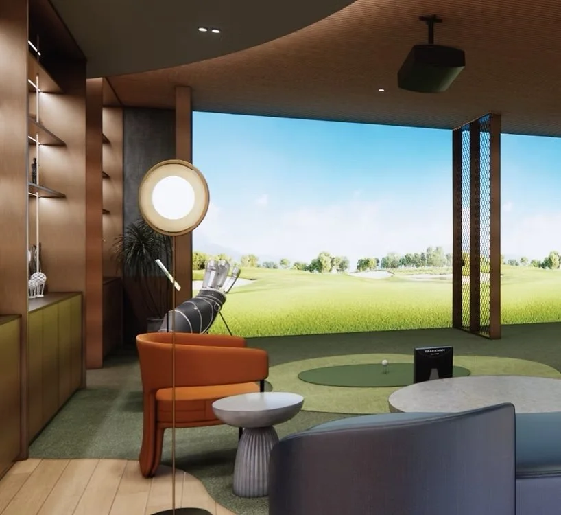 Indoor golf simulator room at The Arden with projection screen and practice area.