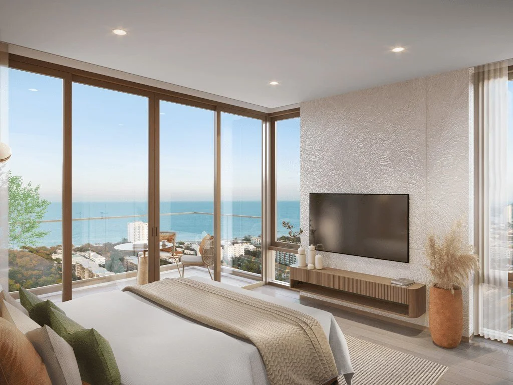 Bedroom interior at Vehha Hua Hin with large windows and sea views in Hua Hin, Thailand.
