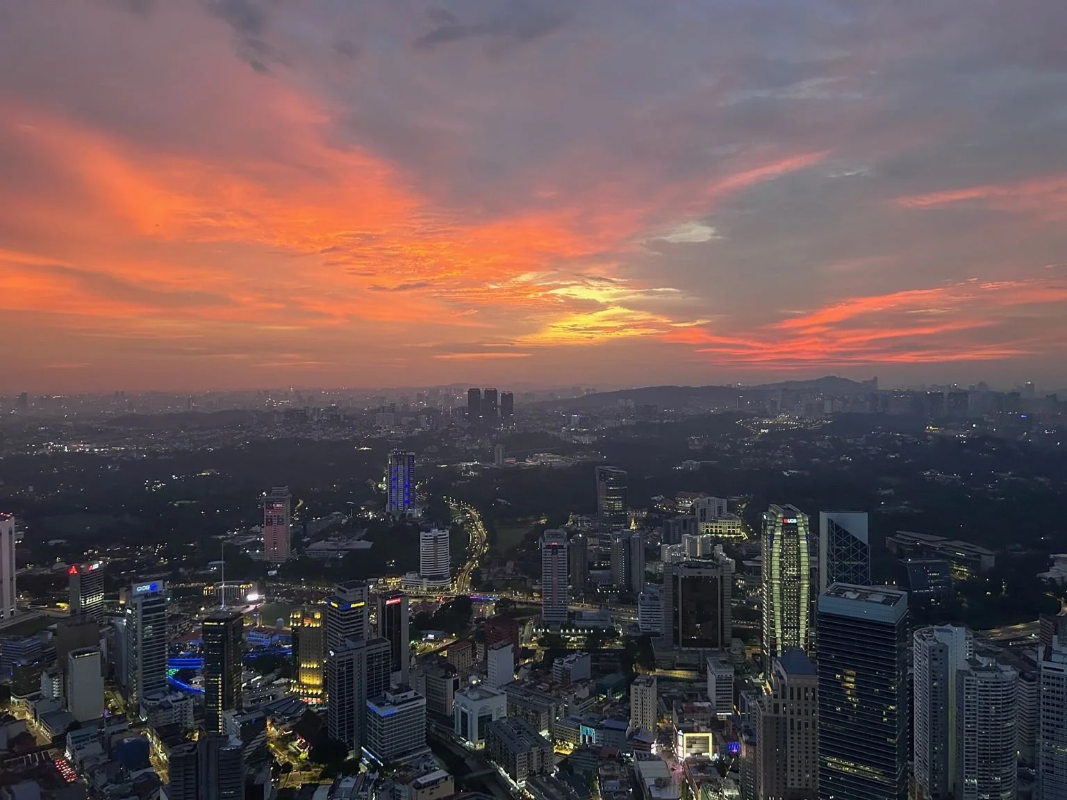 Sunset view over Kuala Lumpur skyline from KL Tower, showing the city’s high-rise districts and surrounding urban landscape.