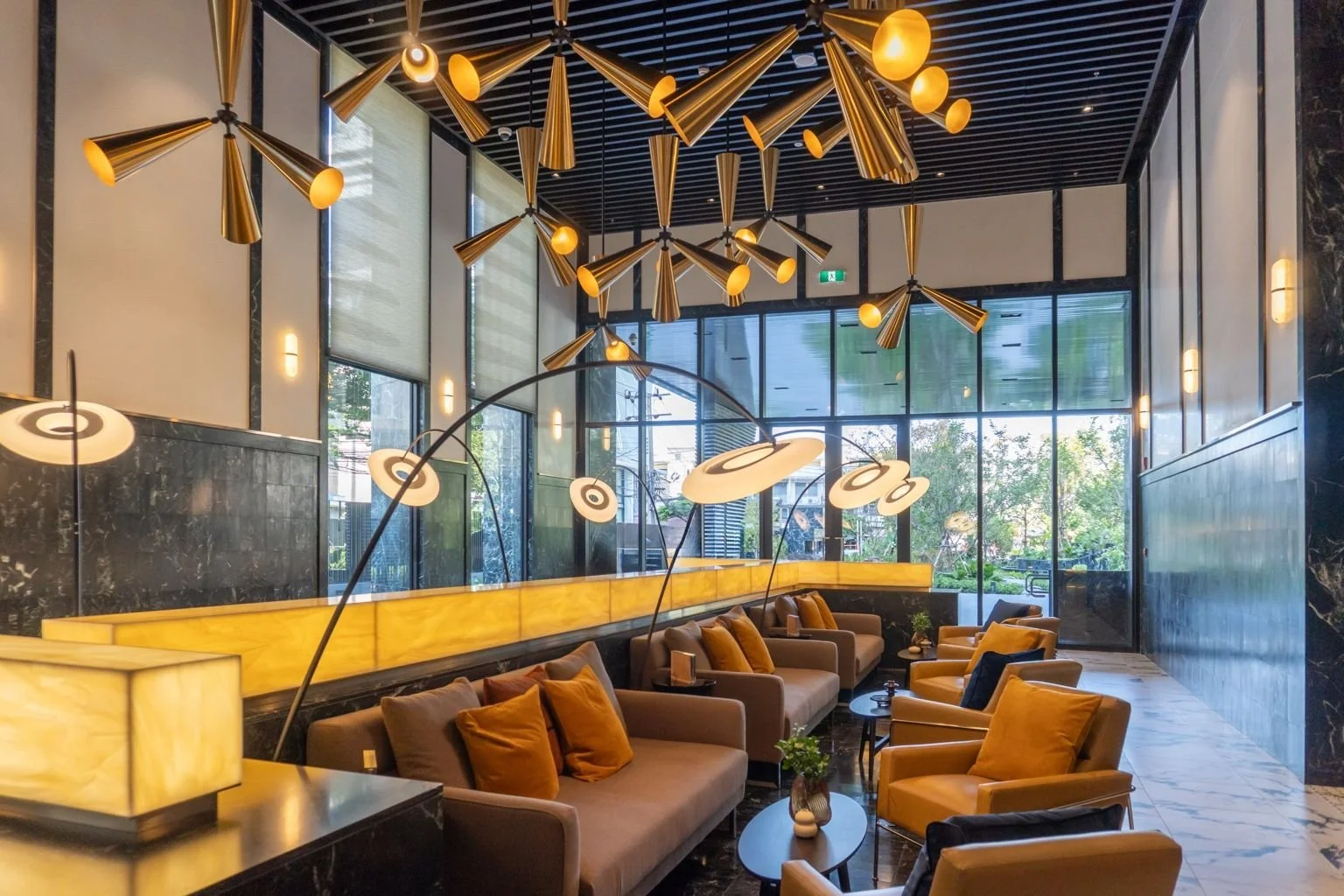 Art Deco lobby at Noble Form Thonglor with high ceilings and luxury seating.