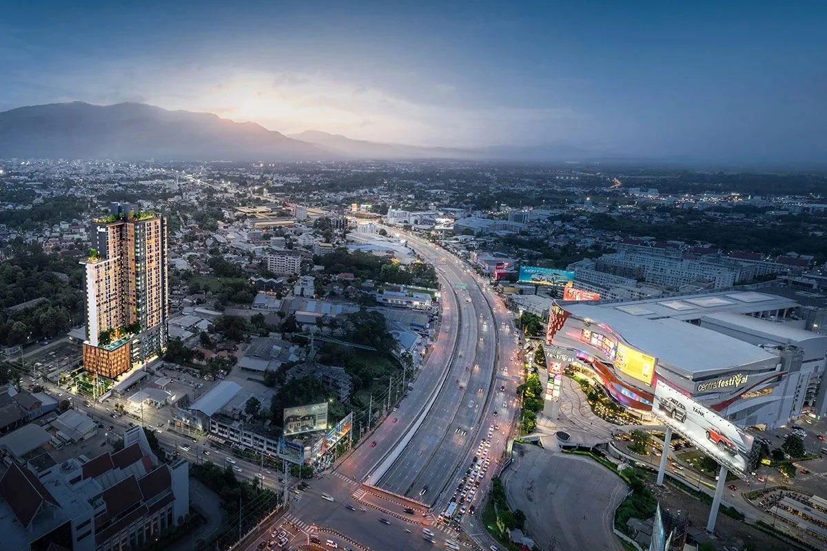 Aerial view of The Base Height Chiang Mai condominium beside Central Festival and main highway with city skyline and mountains in the background.