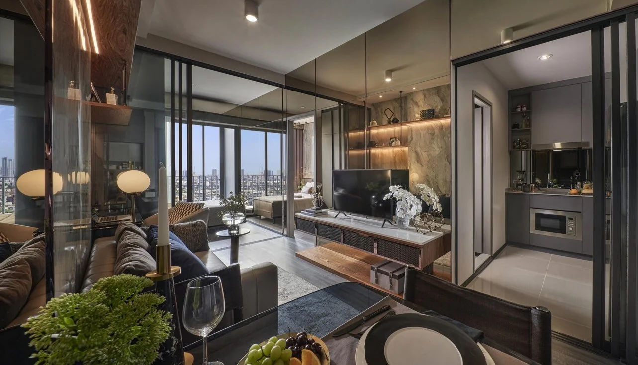Stylish fully furnished condo unit at Ideo Sukhumvit-Rama 4 featuring open-plan living, separate kitchen, and floor-to-ceiling windows with city views