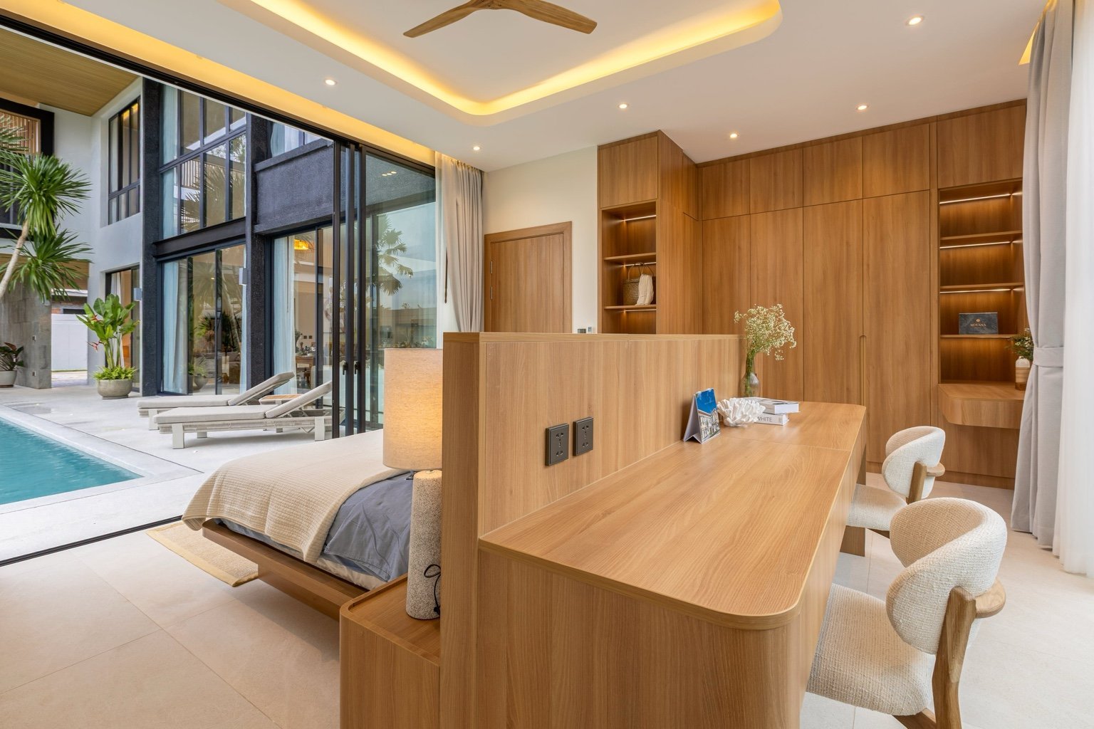 Bedroom at Mouana Grande Chalong Bay with direct access to the private pool and outdoor terrace.