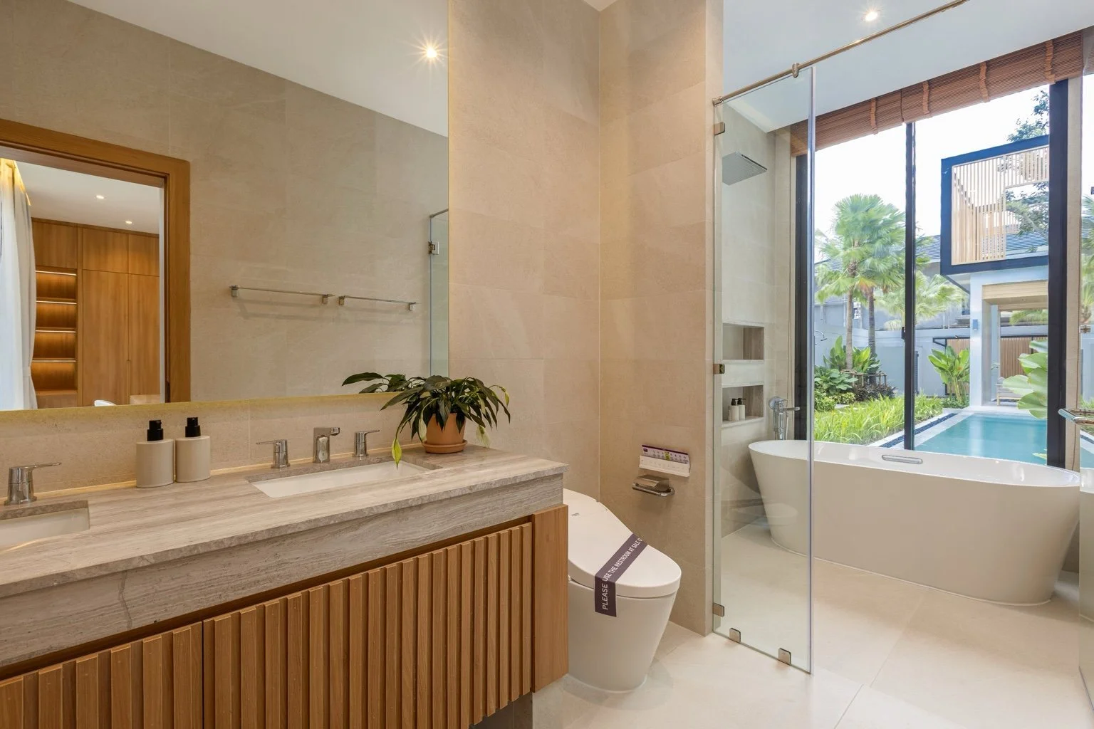 Modern ensuite bathroom at Mouana Grande Chalong Bay featuring double vanity and soaking tub.