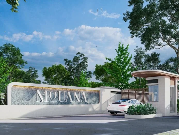 Mouana luxury development entrance with car driving in via a security booth.