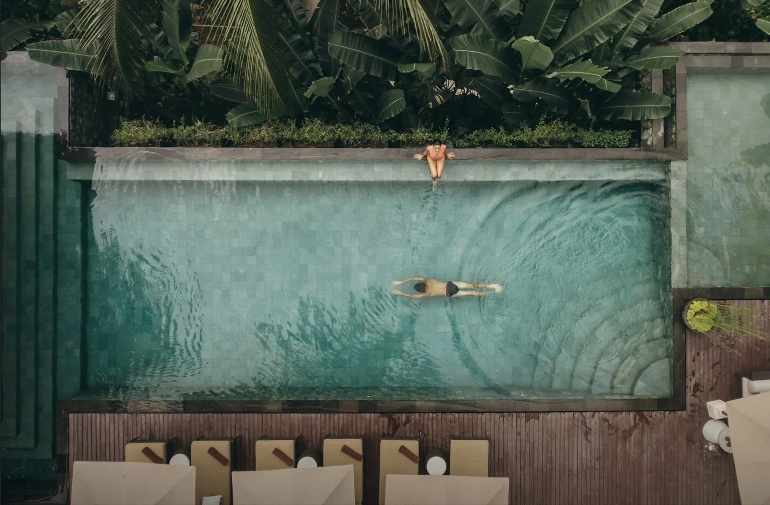 Aerial view of the swimming pool at The Lume by E&O with landscaped pool deck and tropical planting.